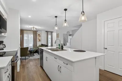 a white kitchen with a sink and a counter at luxury Play House Sleeps 12 Keswick in Edmonton