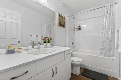 a white bathroom with a sink and a toilet at luxury Play House Sleeps 12 Keswick in Edmonton