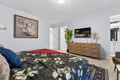 a bedroom with a bed and a tv on a wall at luxury Play House Sleeps 12 Keswick in Edmonton