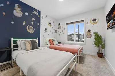 a bedroom with two beds and a window at luxury Play House Sleeps 12 Keswick in Edmonton