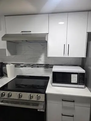 a kitchen with a stove and a microwave at Cozy Suite Near West Edmonton Mall in Edmonton