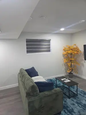 a living room with a couch and a table at Cozy Suite Near West Edmonton Mall in Edmonton