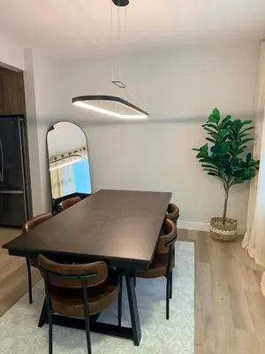 a dining room table with chairs and a potted plant at Cozy and Family-friendly Newly built 3BR Home in Chestermere