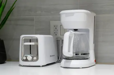 a white blender and a toaster on a counter at New Modern 2BR Suite near UBC Pacific Spirit Park in Vancouver