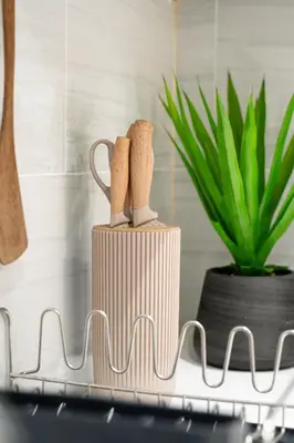 a wooden mug on a counter with a plant at New Modern 2BR Suite near UBC Pacific Spirit Park in Vancouver