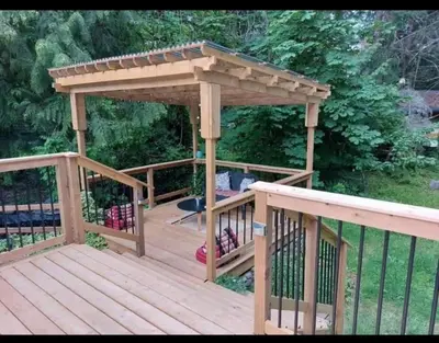a wooden gazebo with a roof on a deck at Ships Point Wellness INC in Fanny Bay