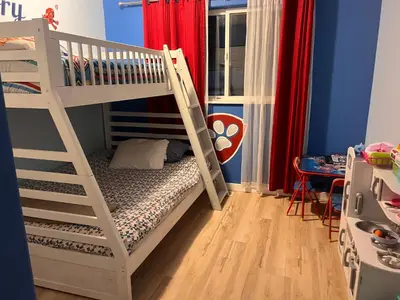 a white bunk bed in a blue room at Ships Point Wellness INC in Fanny Bay