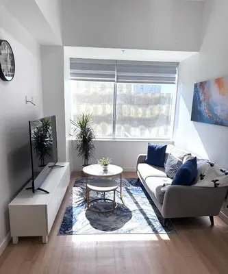a living room with a couch and a table at Cozy 1-Bedroom with Natural lights in Edmonton