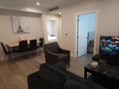 a living room with a couch and a dining room at Vancouver Family Condo 2 Bedrooms 2 Baths Near UBC & Parks in Vancouver