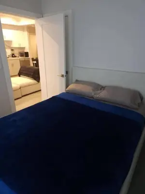 a bedroom with a bed with a blue blanket at Vancouver Family Condo 2 Bedrooms 2 Baths Near UBC & Parks in Vancouver