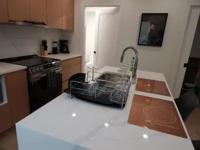 a kitchen with a dish drying rack on the counter at Vancouver Townhouse Family-Friendly with Street Parking & Balcony in Vancouver