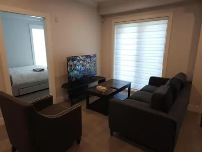 a living room with a couch and a bed at Vancouver Townhouse 2 Queen Beds Kitchen Street Parking - Perfect for Families in Vancouver
