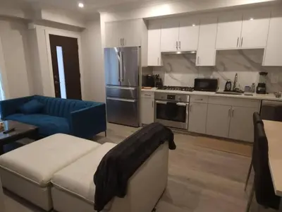 a living room with a couch and a kitchen at Vancouver Townhouse 2 Queen Beds Kitchen Street Parking - Perfect for Families in Vancouver