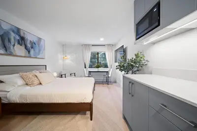 a bedroom with a bed and a tv on a wall at The Alpine Alcove w Pool & Hot Tub in Whistler