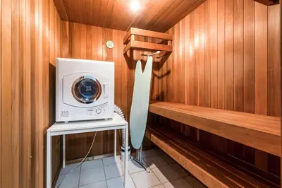 a washer and dryer in a sauna at Comfortable Family Home,South Granville in Vancouver