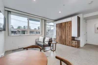 a living room with a table and a chair at Modern Downtown Studio Bedroom Walk Everywhere in Vancouver