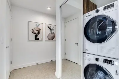 a laundry room with a washer and dryer at Modern Downtown Studio Bedroom Walk Everywhere in Vancouver