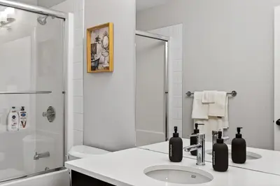 a white bathroom with a sink and a shower at modern 3bedroom space sleeps 6 free parking in Edmonton