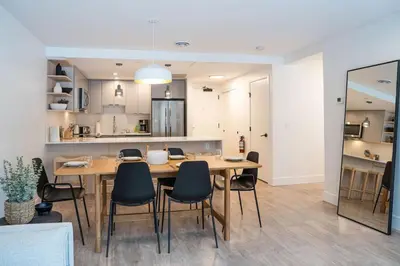 a dining room and kitchen with a table and chairs at Qs Hideaway in Mackenzie Village in Revelstoke