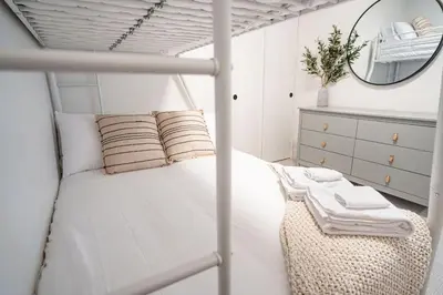 a bedroom with a bunk bed with a mirror at Qs Hideaway in Mackenzie Village in Revelstoke