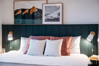 a bedroom with a large bed with white pillows at The Ceili Cottage in Mackenzie Village in Revelstoke