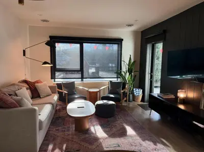 a living room with a couch and a table at The Ceili Cottage in Mackenzie Village in Revelstoke