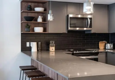 a kitchen with a counter top and a microwave at The Peaks and Birdies in Mackenzie Village, Revelstoke in Revelstoke