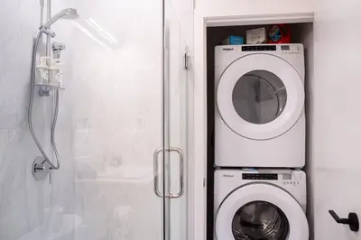 a washing machine in a bathroom next to a shower at Bluebird Daze in Mackenzie Village in Revelstoke