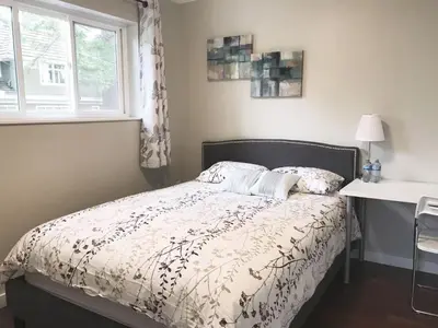a bedroom with a bed and a window and a desk at EVE'S Room Connect YVR Downtown UBC in Vancouver