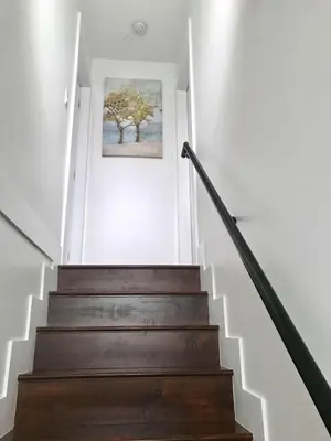 a stairway with a picture of a tree on the wall at EVE'S Room Connect YVR Downtown UBC in Vancouver