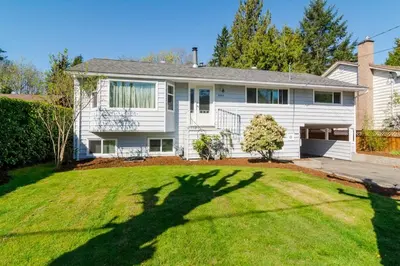 a large white house with a large yard at Quiet Furnished Room Near Transit and Hospital long stays in Surrey