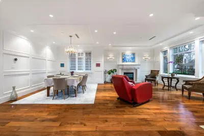 a living room with a table and a red chair at An Amazing StarHouse in Westside Vancouver in Vancouver