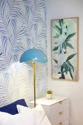 a bedroom with a blue lamp and a blue and white wall at Quiet & Walkable - Stampede, BMO, Nightlife & Eats in Calgary