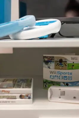 a shelf with wii games and a wii sports book at Quiet & Walkable - Stampede, BMO, Nightlife & Eats in Calgary