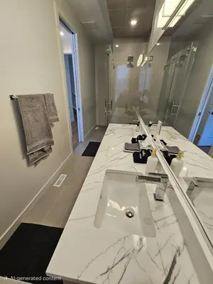 a white bathroom with a sink and a mirror at Shaganappi 2BR with private Baths, Walk to CTrain, Garage Parking, Full Kitchen in Calgary