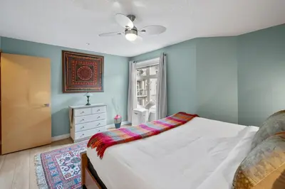 a bedroom with a white bed and a window at 2 Bedroom Condo Banff, Canmore sleeps 6 comfortably in Canmore
