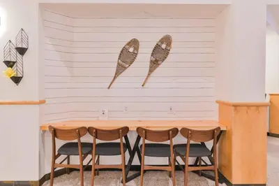 a table and four chairs against a wall with two wings on it at 2 Bedroom Condo Banff, Canmore sleeps 6 comfortably in Canmore