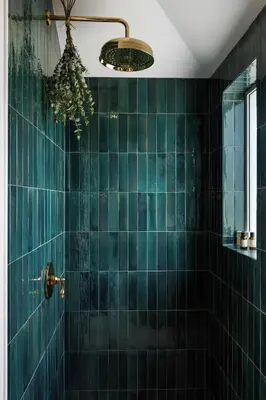 a green tiled bathroom with a shower with a chandelier at The Garden Studio in Victoria
