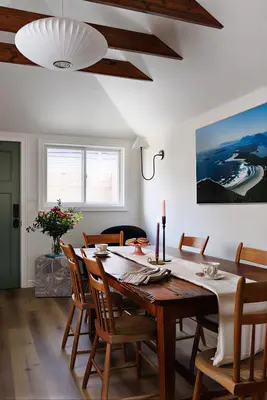 a dining room with a wooden table and chairs at The Garden Studio in Victoria