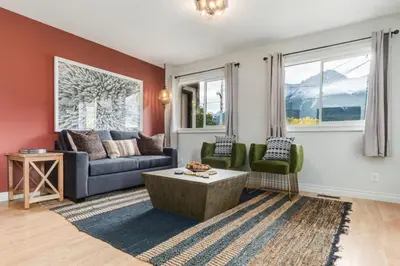 a living room with a couch and two chairs at 2BR Red Cedar Lodge near Banff with Mountain Views in Canmore