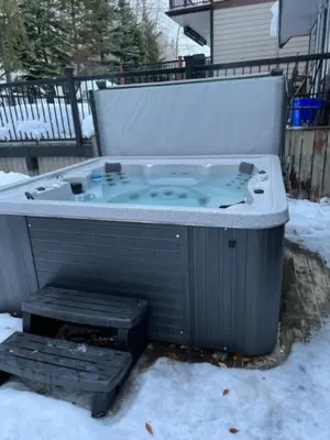 a jacuzzi tub sitting in the snow at 3BR Oasis Private Hot Tub and Sauna Walk to Ski Hill in Kimberley