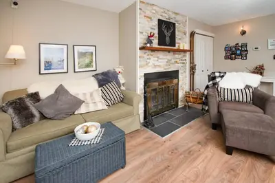a living room with a couch and a fireplace at 3BR Oasis Private Hot Tub and Sauna Walk to Ski Hill in Kimberley