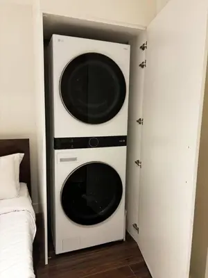 two microwaves are mounted on a wall next to a bed at Calgary Mini Manor Near DT Sleeps 8 Prime Location in Calgary