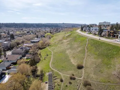 an aerial view of a grassy hill next to a road at Calgary Mini Manor Near DT Sleeps 8 Prime Location in Calgary