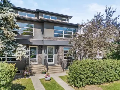 an exterior view of a house with bushes at Calgary Mini Manor Near DT Sleeps 8 Prime Location in Calgary