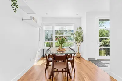 a dining room with a glass table and chairs at Calgary Mini Manor Near DT Sleeps 8 Prime Location in Calgary