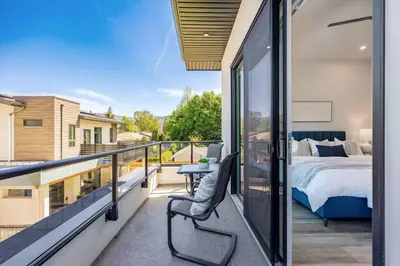 a balcony with a bedroom and a bed at Luxurious 4BR Beach Retreat with Backyard and Balcony in Penticton
