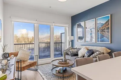 a living room with a couch and some windows at Cozy 2BR apartment in Golden near DT in Golden