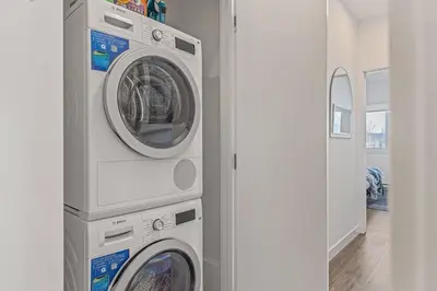 two washing machines are stacked next to each other in a room at Cozy 2BR apartment in Golden near DT in Golden