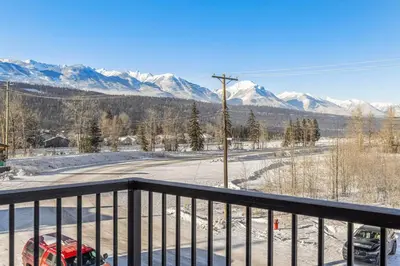 a balcony with a view of snow covered mountains at Cozy 2BR apartment in Golden near DT in Golden
